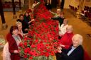 The poppies knitted by the community were sewn on to netting by church members