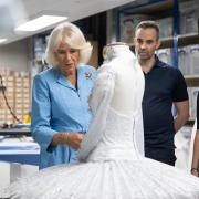 Queen Camilla looks at ballet costumes being made